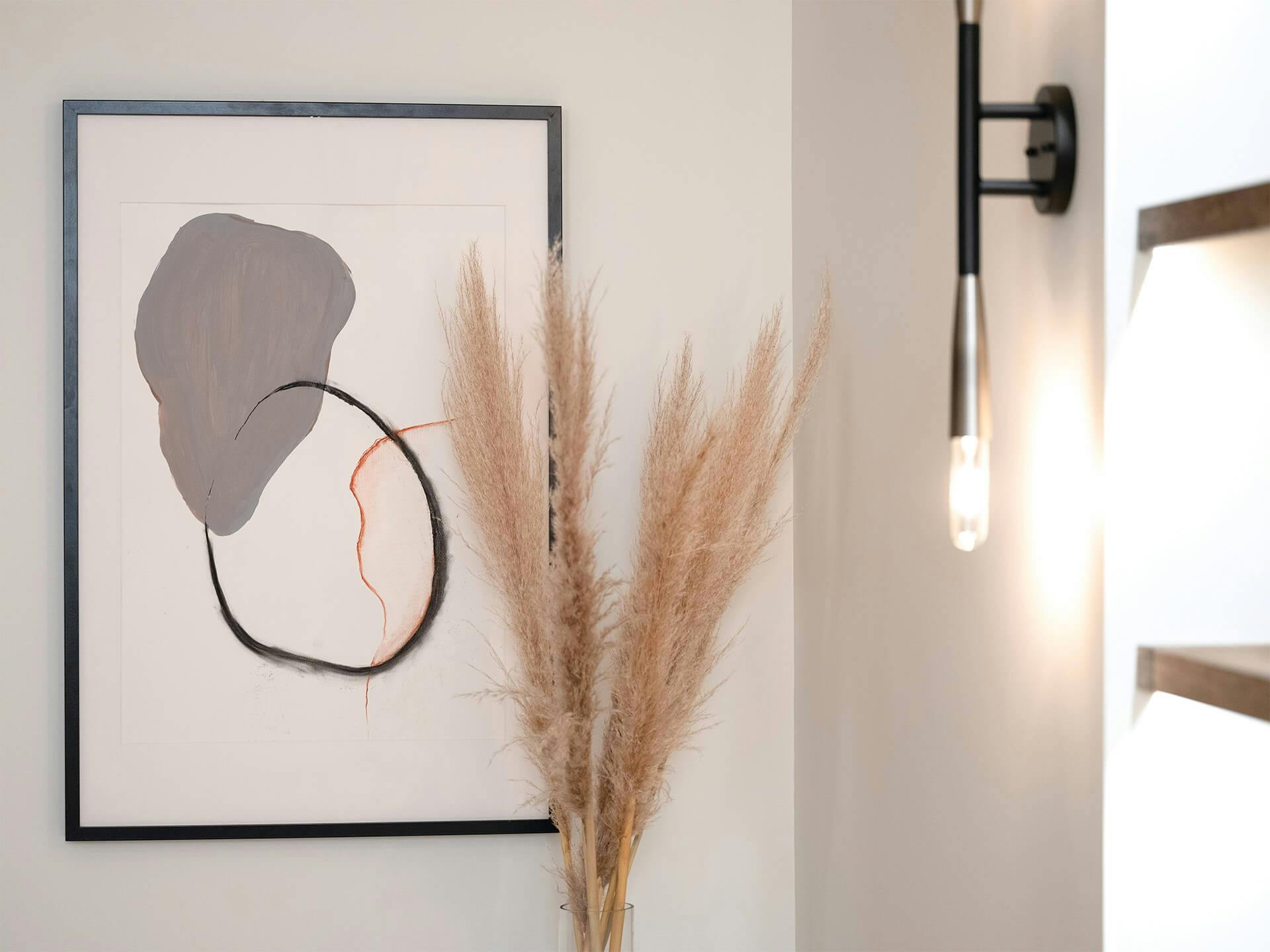 Corner of a room with a plant and featuring Branches wall sconce