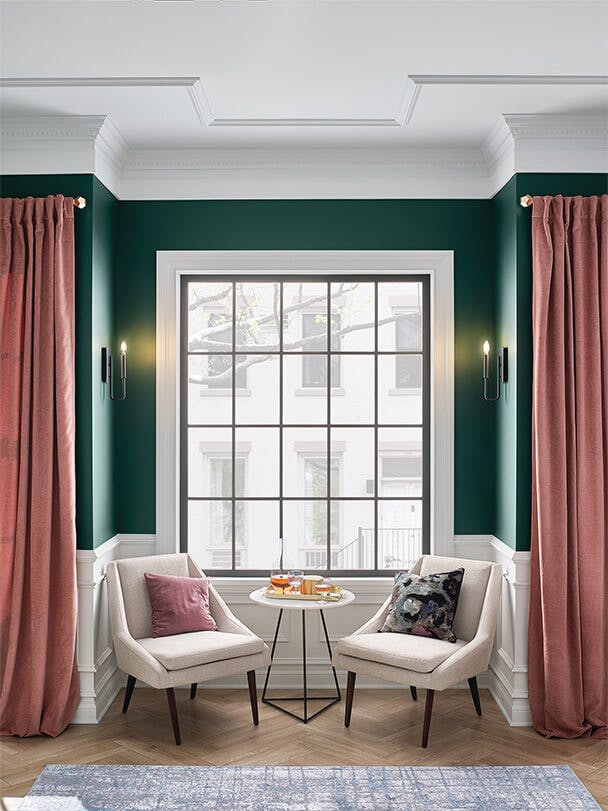 Daytime bay window photo with two chairs and Alden wall sconces