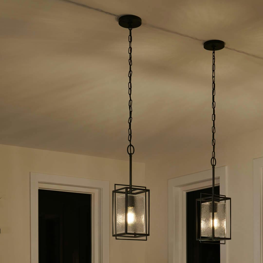 Night time kitchen with Edinborough 1 Light Mini Pendant in Textured Black with Clear Hammered Glass
