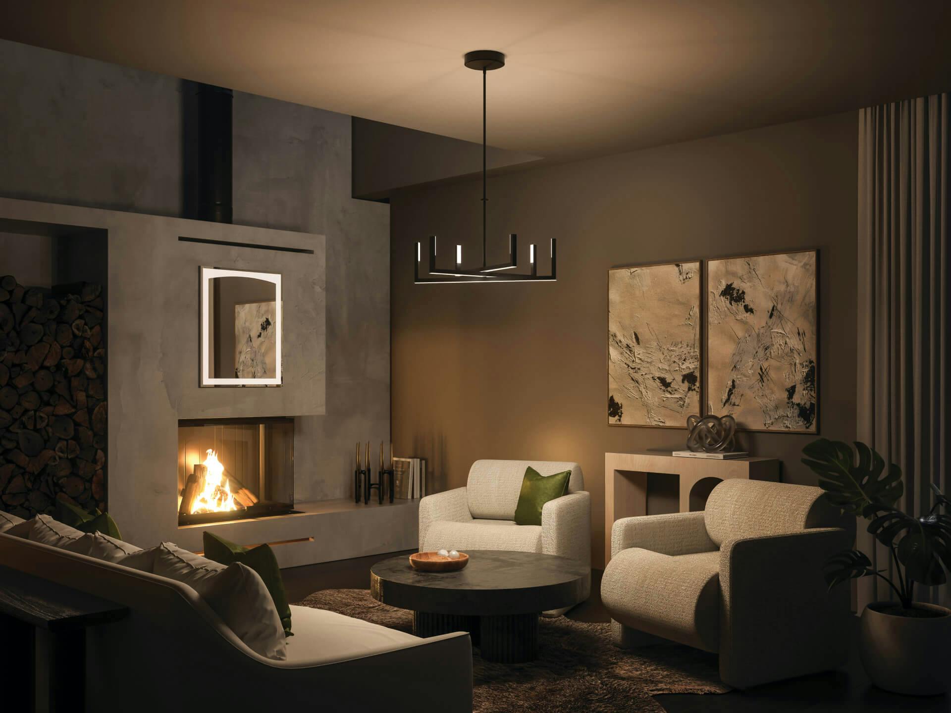 Living room at night with a lit fireplace and featuring a priam chandelier in black finish.