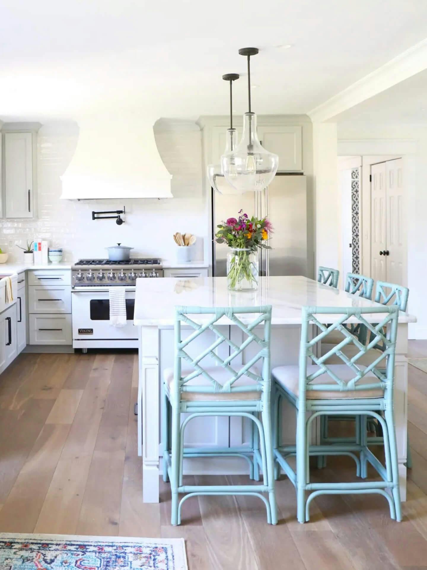 Bright mostly white kitchen with marble kitchen island