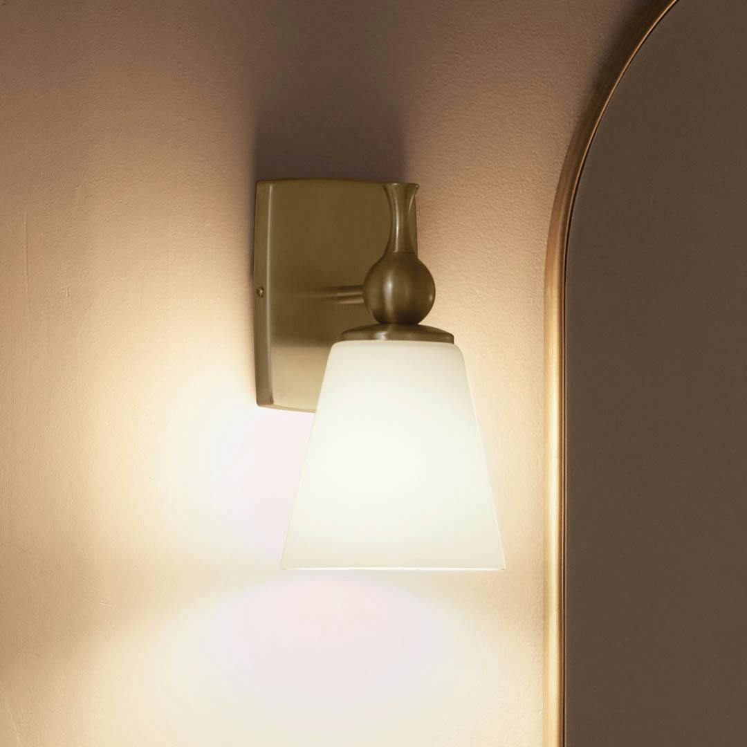 Night time bathroom with Cosabella™ 6" 1 Light Wall Sconce Champagne Bronze