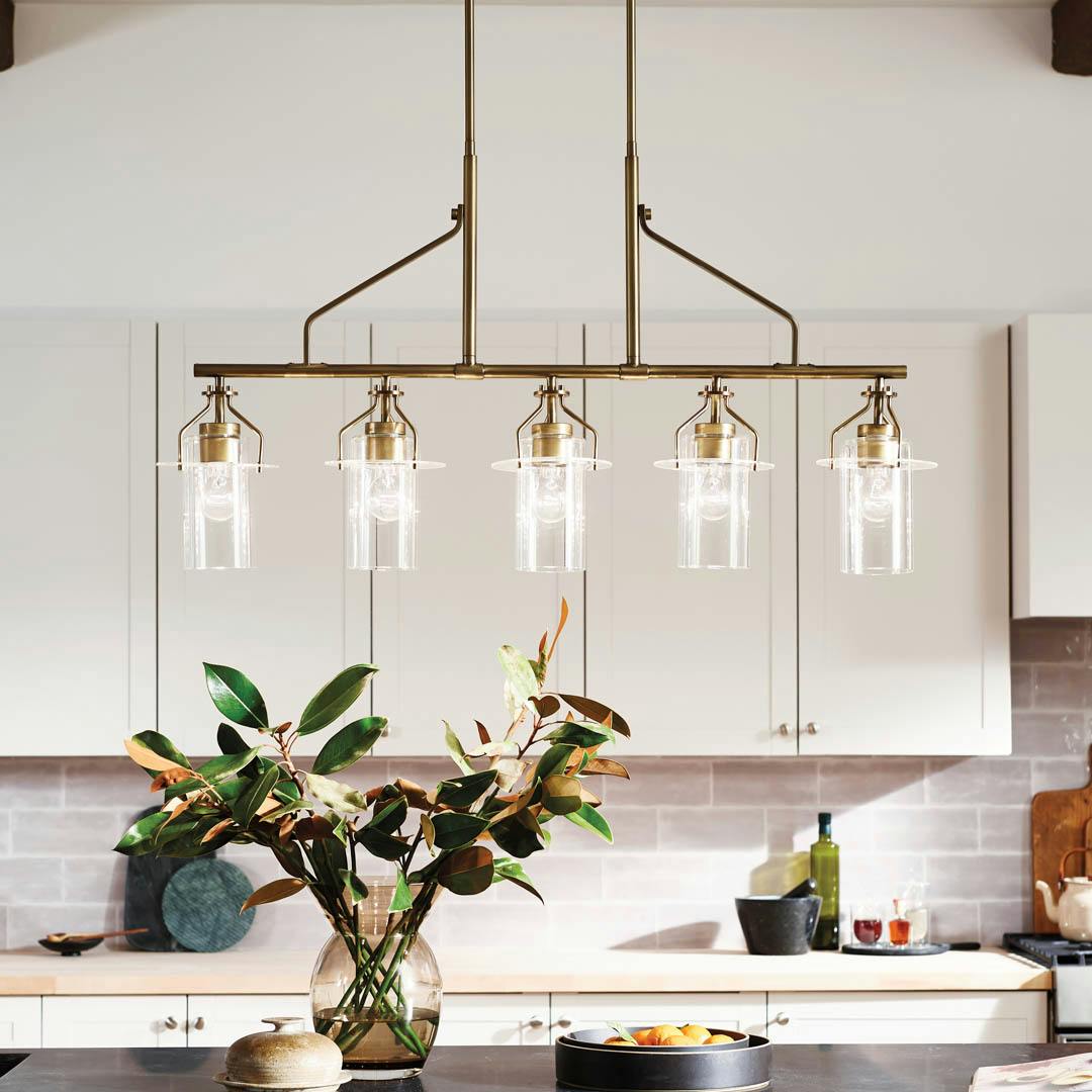 Day time kitchen with Everett 42 Inch 5 Light Linear Chandelier with Clear Glass in Natural Brass
