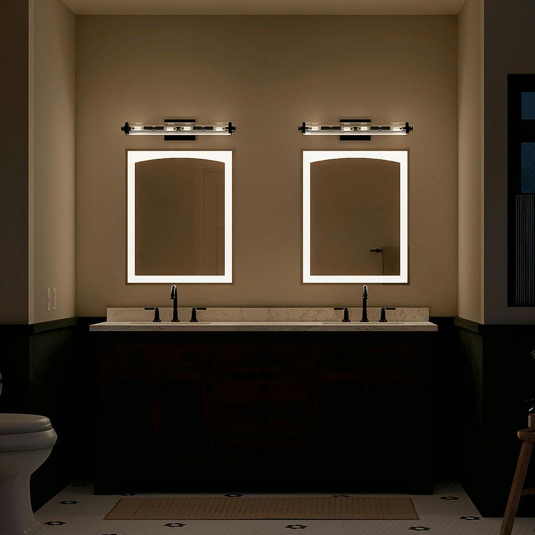 Bathroom at night with the Azores 25" 4-Light Linear Vanity Light in Black