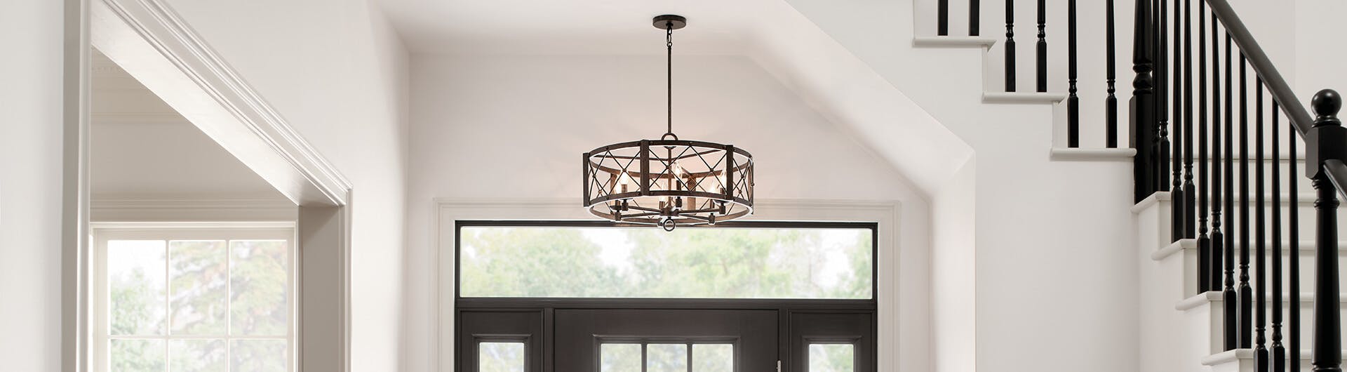 Daytime scene of a foyer with an Arborwood chandelier lit above the front door