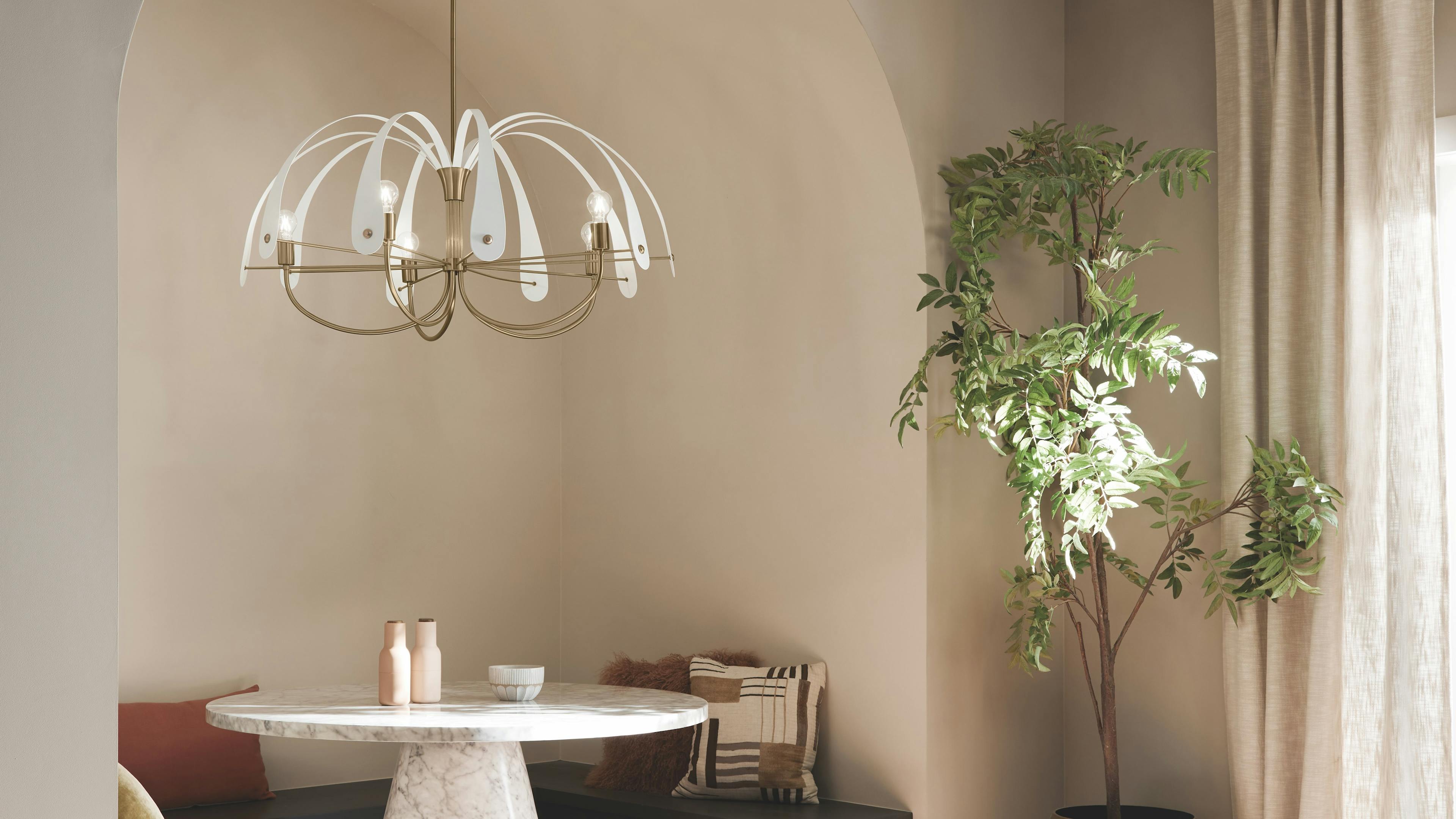 Dining nook with table and plants and Petal chandelier in champagne bronze and white