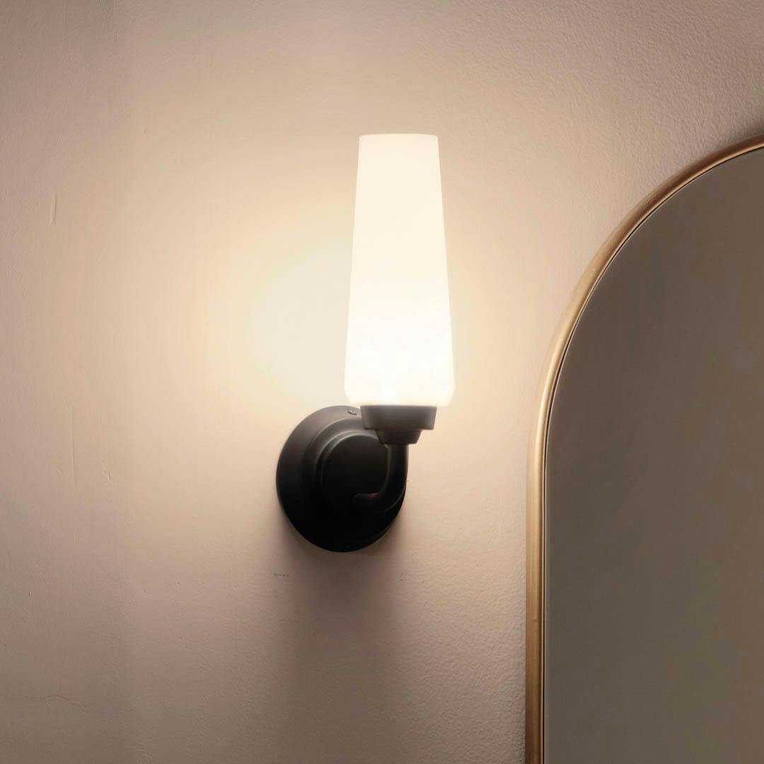 Night time bathroom with Truby 11.5 Inch 1 Light Wall Sconce with Satin Etched Cased Opal Glass in Black