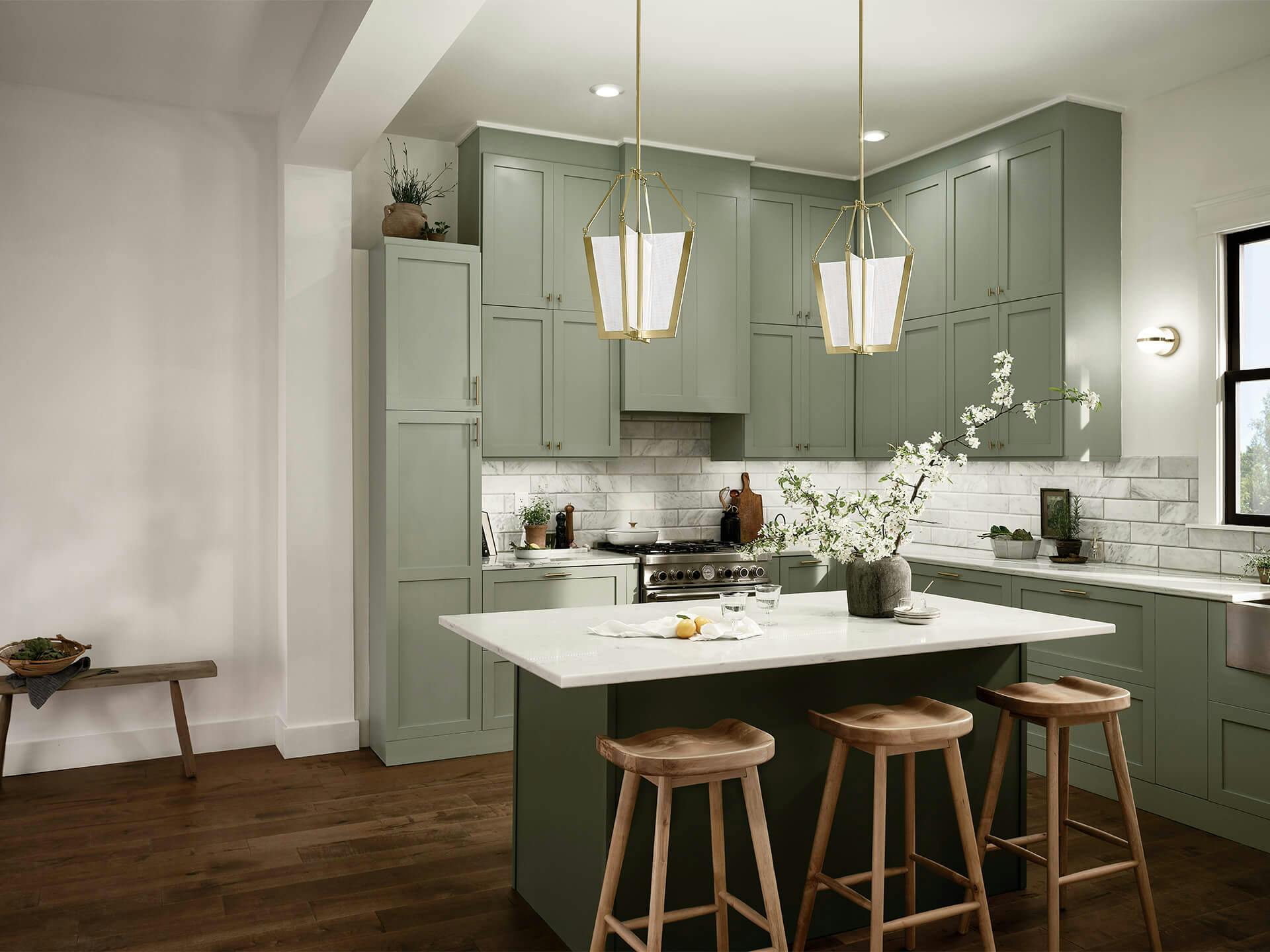A kitchen with 2 Calters pendants above a white marble kitchen island in the daytime with the lights turned on