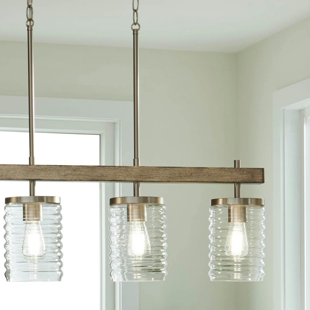 Day time kitchen with Maritime 4 Light Linear Chandelier in Brushed Nickel and Distressed Antique Gray with Ribbed Glass