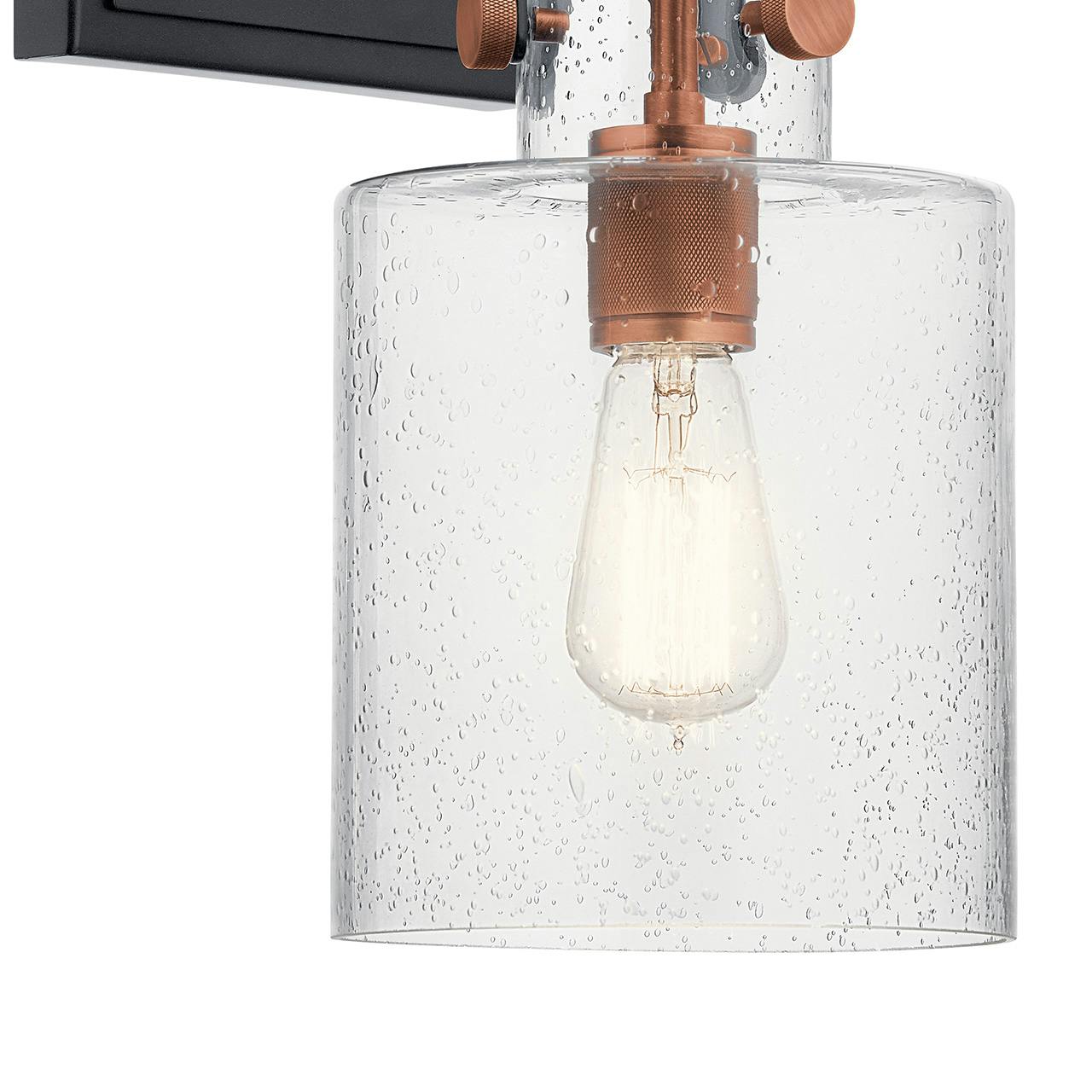 Close up view of the Kitner 1 Light Wall Sconce Black & Copper on a white background