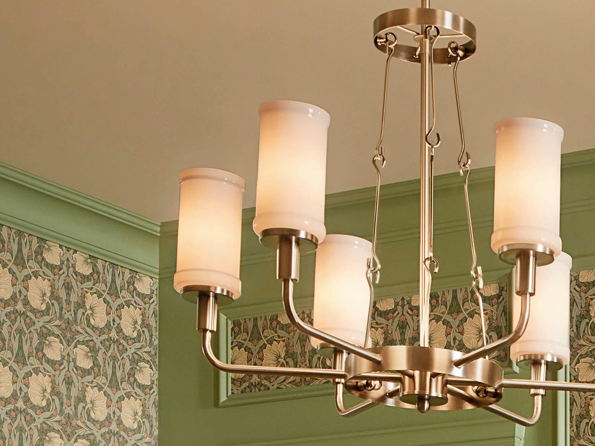 Close up of a brass finish Vetivene chandelier with milky opaque shades