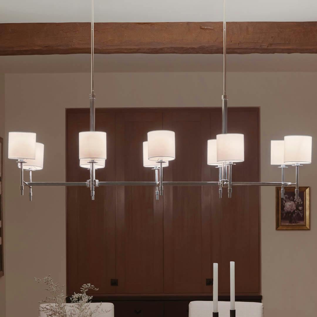 Night time dining room with Ali 56.5" 10 Light Linear Chandelier Polished Nickel