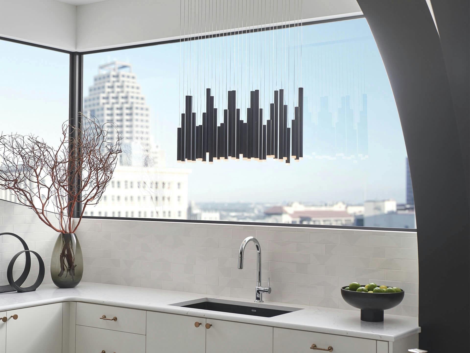 Soho 11 Light rectangular pendant cluster hanging over kitchen sink in high rise apartment