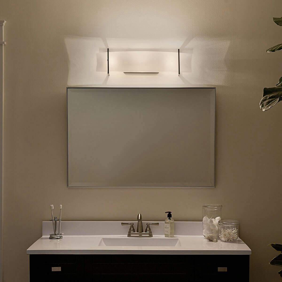 Night time Bathroom featuring CrescentView vanity light 45220NI