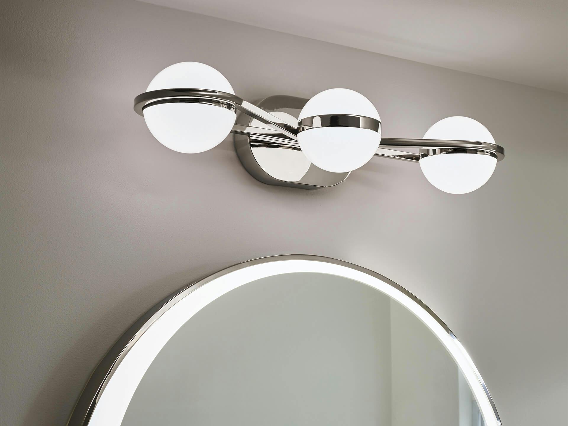Polished Nickel 3 light Brettin Vanity light mounted above bathroom mirror