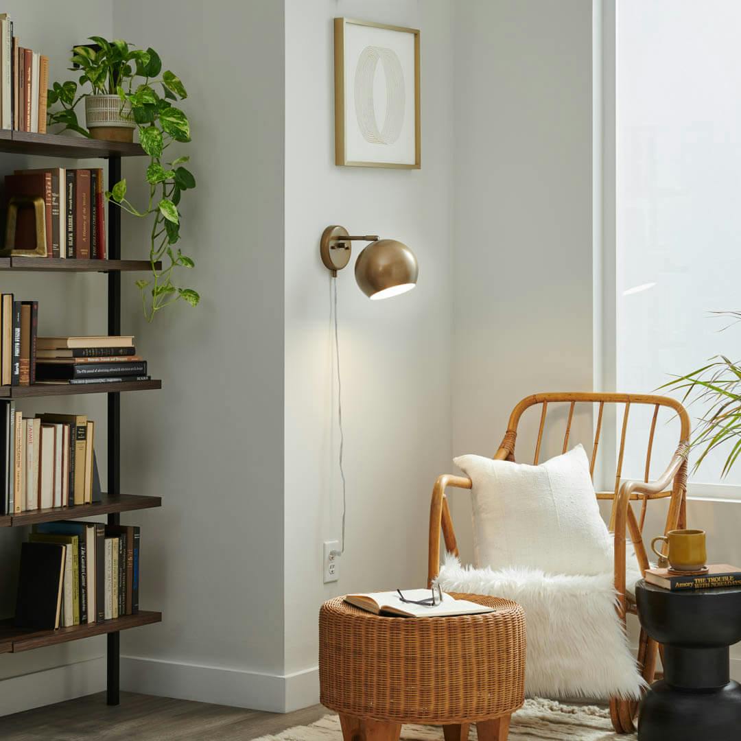 Day time reading nook with Lemmy 7.5 Inch 1 Light Plug-In Wall Sconce in Natural Brass