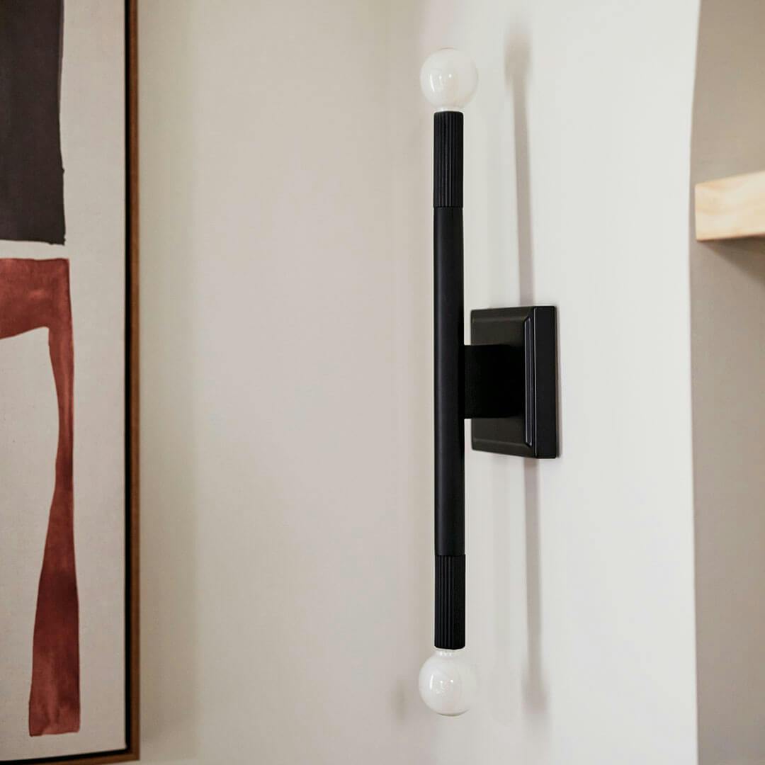 Day time living room with the Odensa 17 Inch 2 Light Wall Sconce in Black