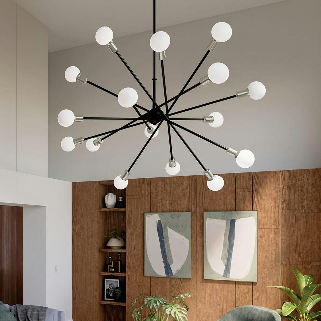 A lounge in daylight with the Armstrong 63" 16 Light Chandelier in Black