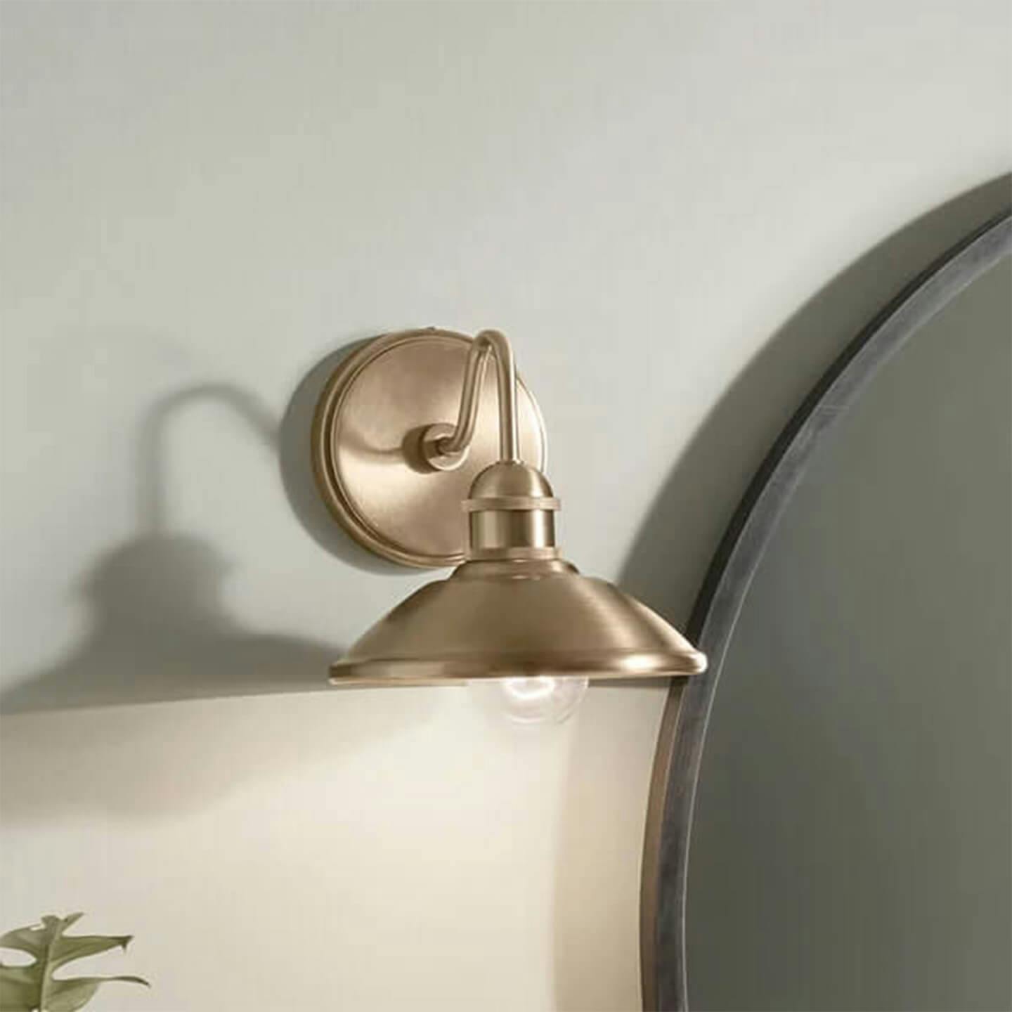 Champagne Bonze Clyde Wall Sconce mounted next to bed