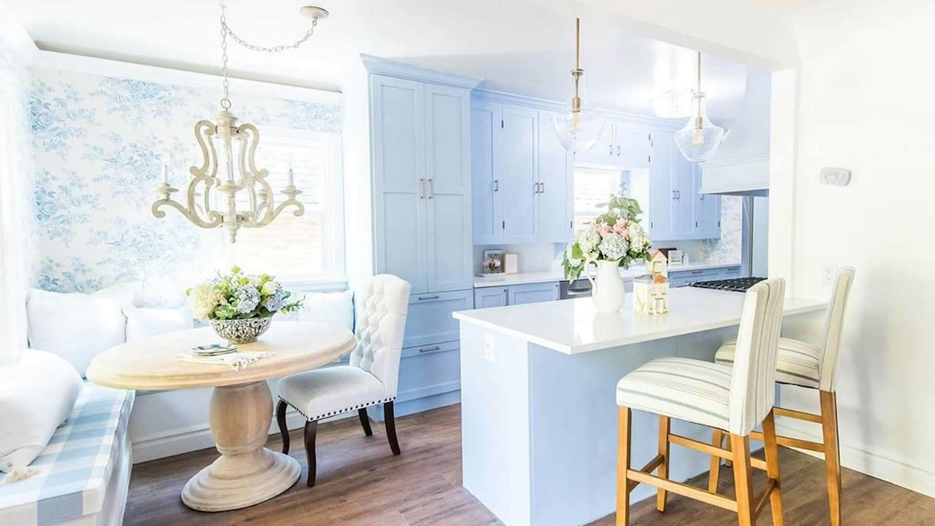 Powder blue kitchen and breakfast nook with variety of pendant and chandeliers