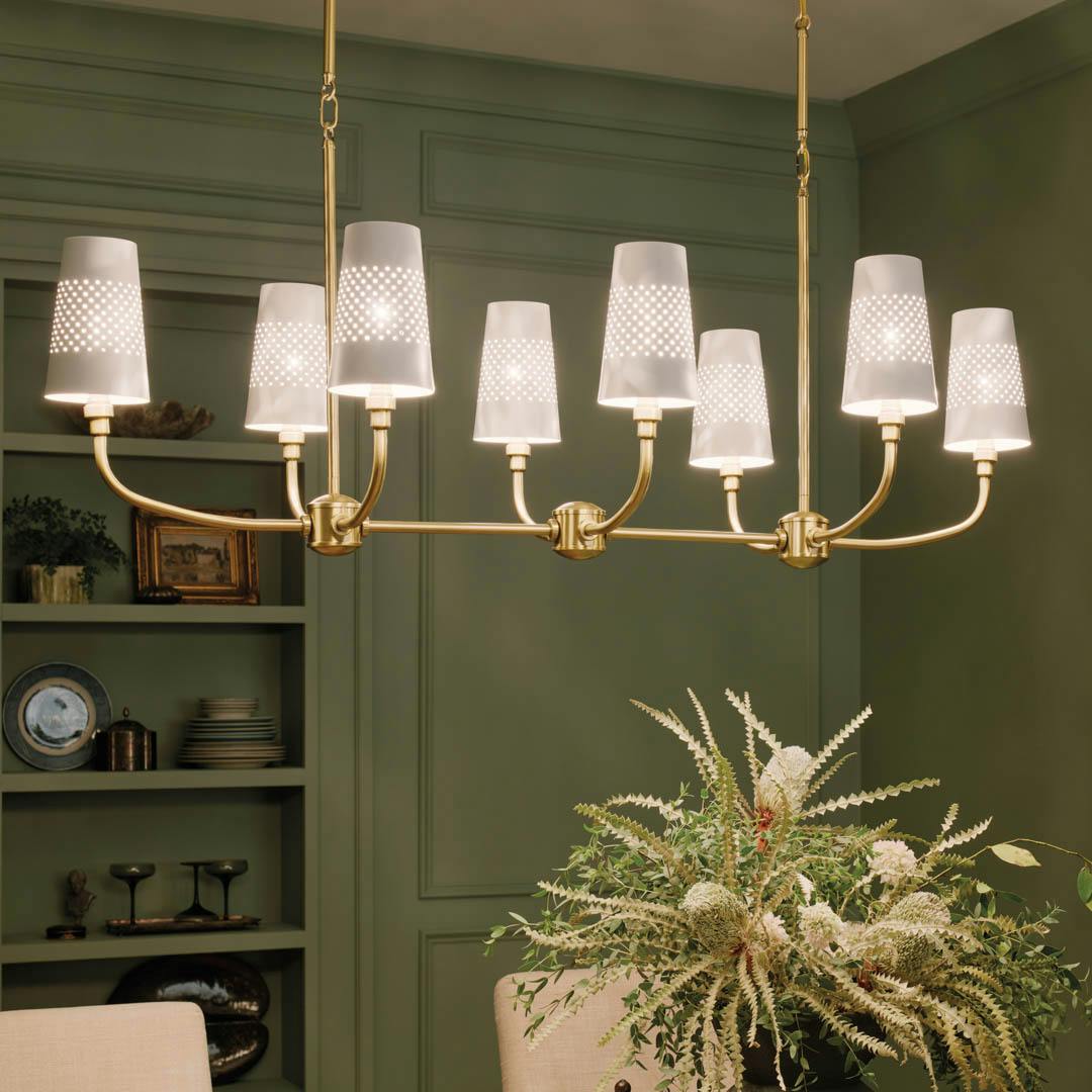 Night time dining room with Adeena 47.25" 8 Light Linear Chandelier Brushed Natural Brass
