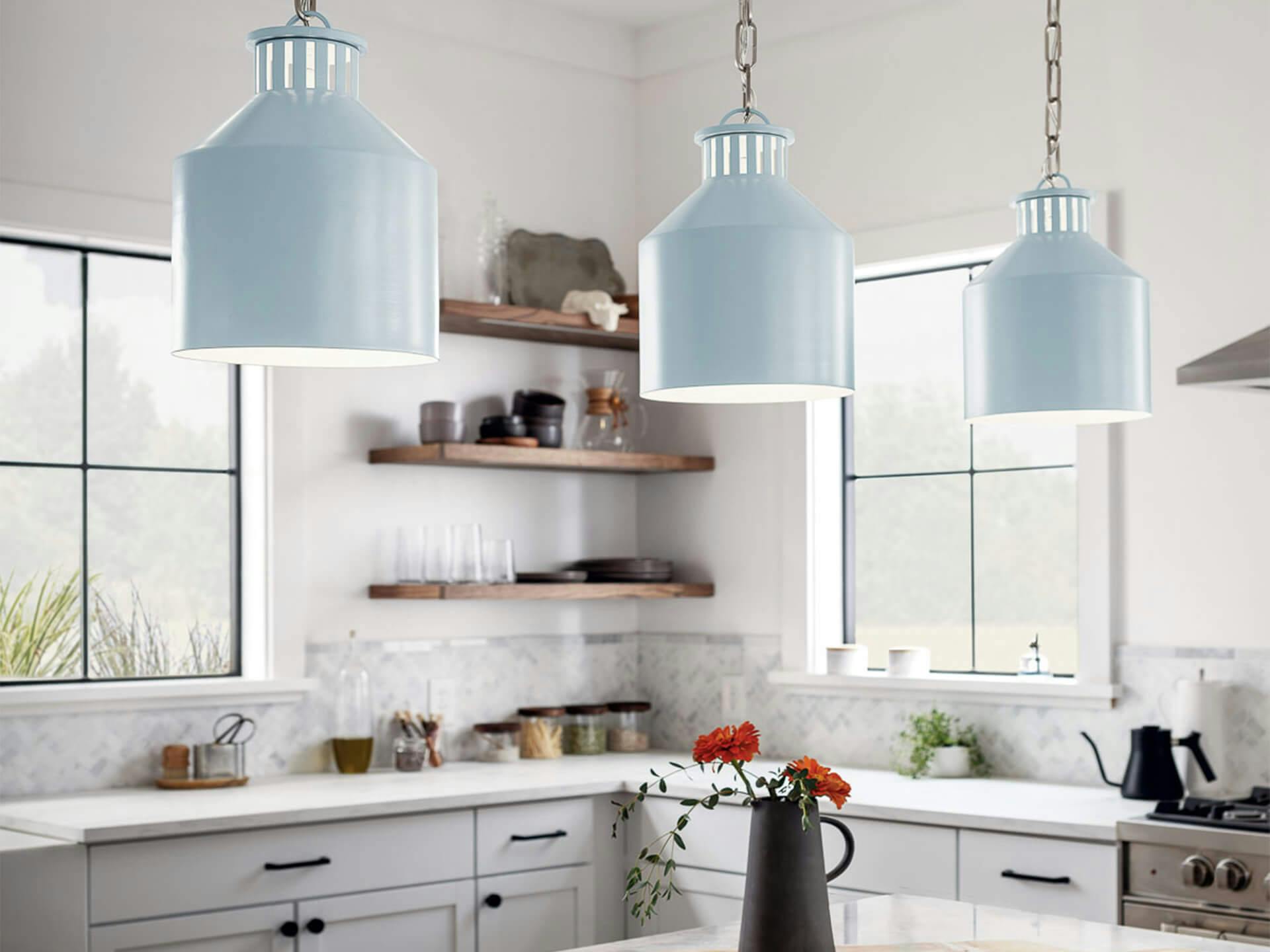 3 Montauk pendants hanging over an island kitchen table all on in the day