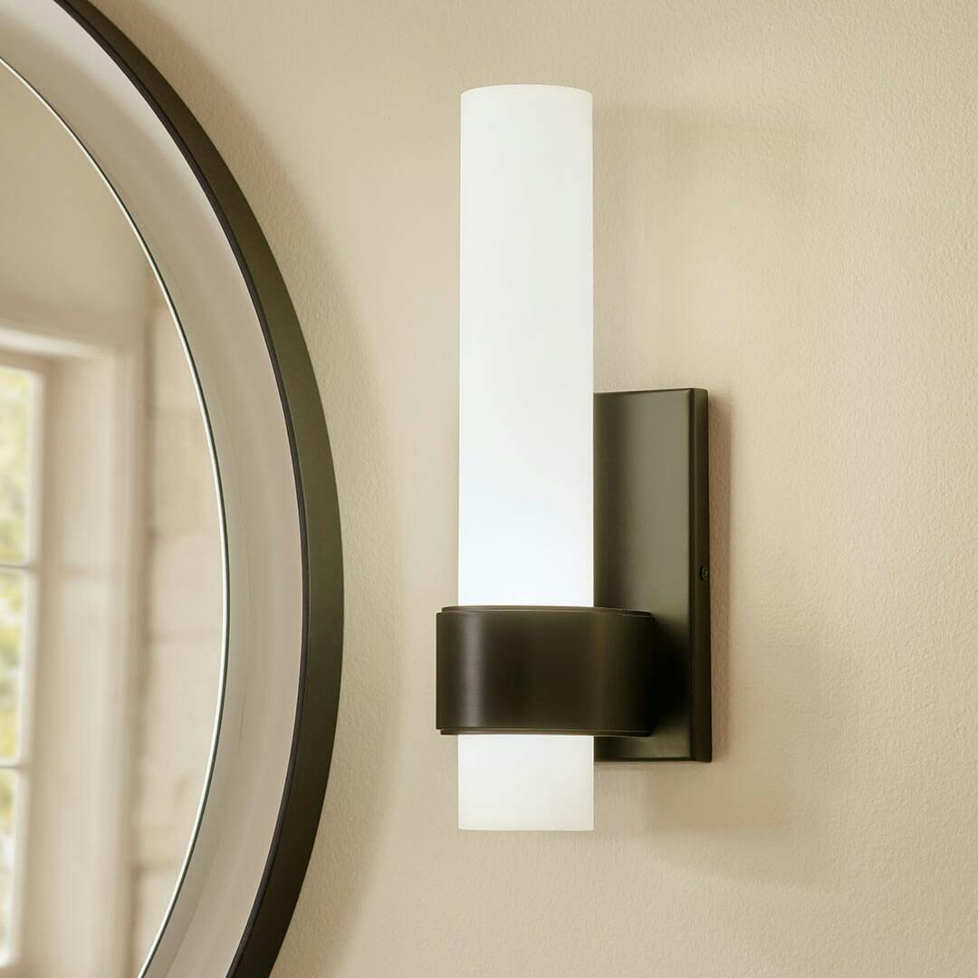 Bathroom in the day time with the Izza 13.25 Inch 1 Light LED Wall Sconce in Matte Black