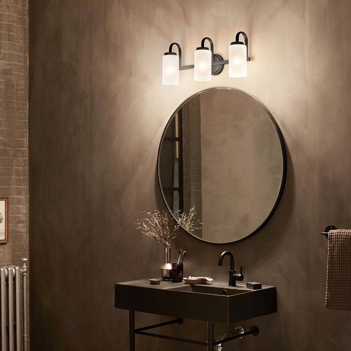 Night time bathroom with Kennewick 3 light vanity light in black