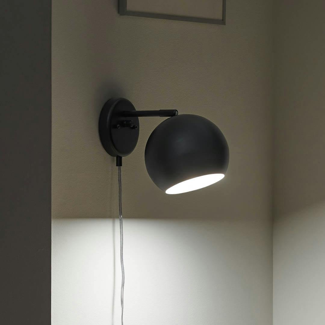 Night time reading nook with Lemmy 7.5 Inch 1 Light Plug-In Wall Sconce in Matte Black