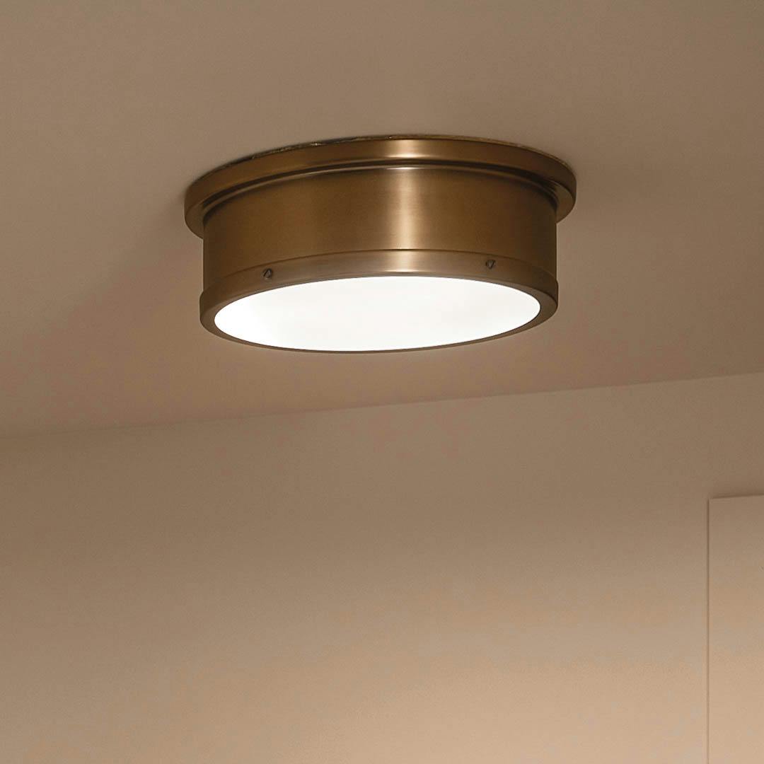 Night time entryway with Serca 18" 3 Light Flush Mount Brushed Natural Brass