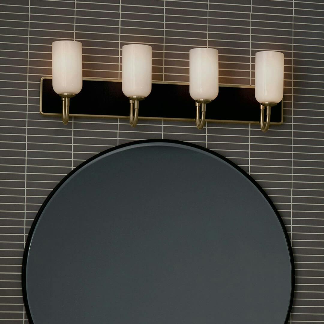 Night time bathroom with the Solia 32 Inch 4 Light Vanity with Opal Glass in Champagne Bronze with Black