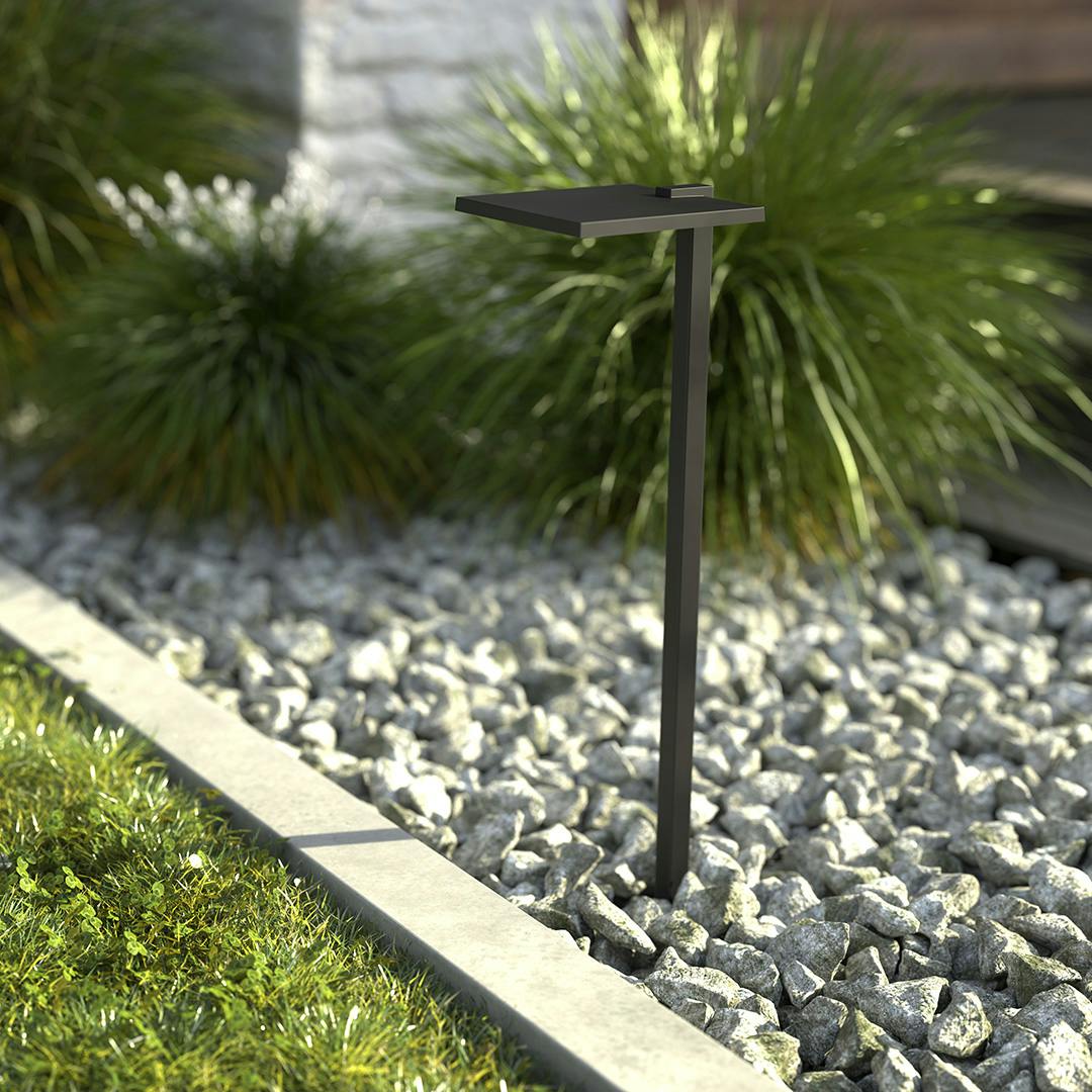 The 12 Volt 2700K LED 6" Shallow Shade Path Light in Textured Black outside during the day