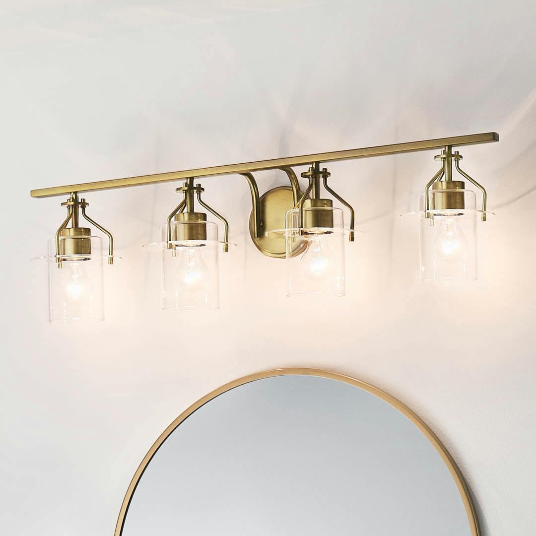Day time bathroom with Everett 34.25 Inch 4 Light Vanity Light with Clear Glass in Natural Brass