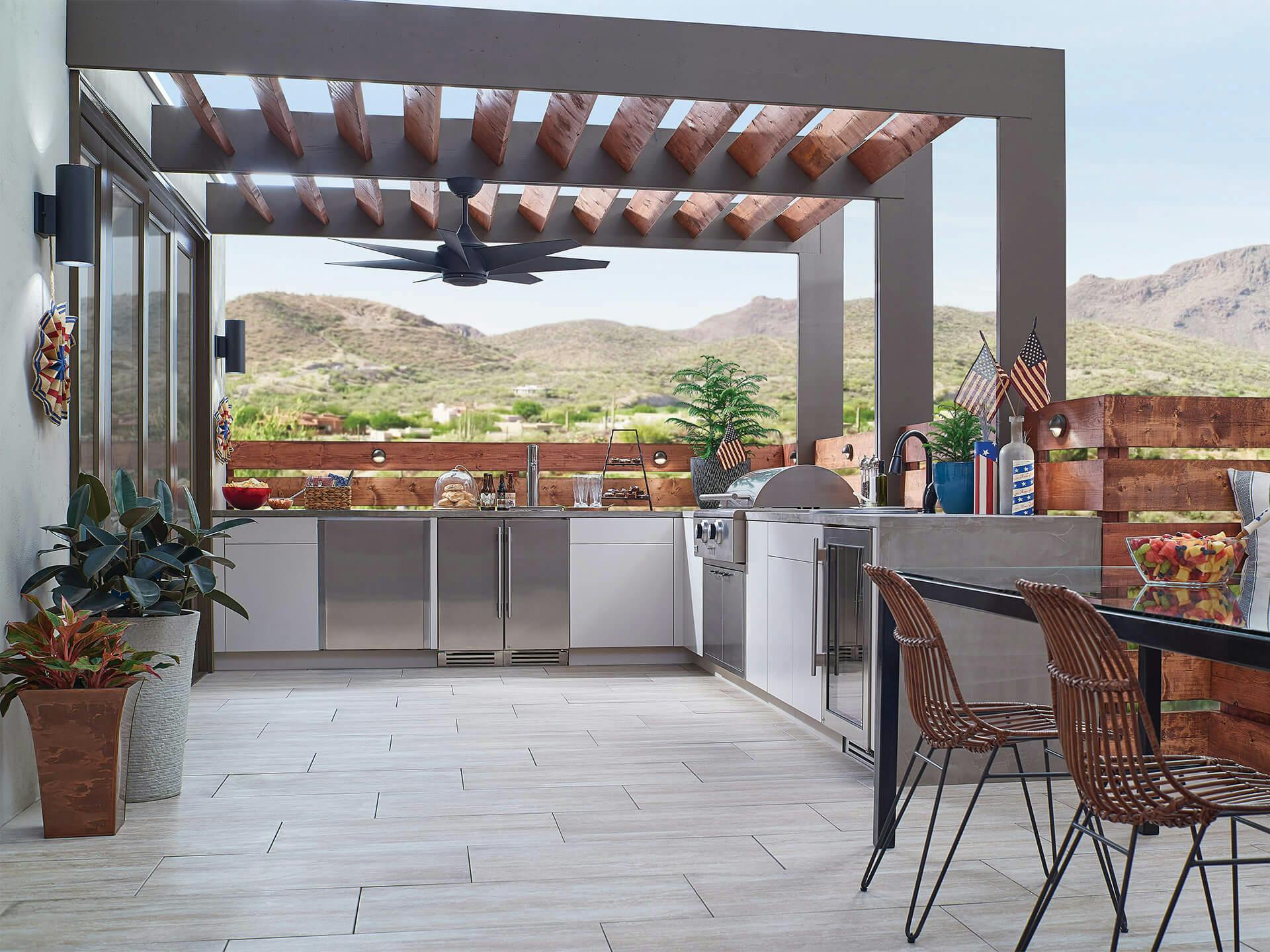 Exterior image of an outdoor kitchen with a Lehrll fan in the day 