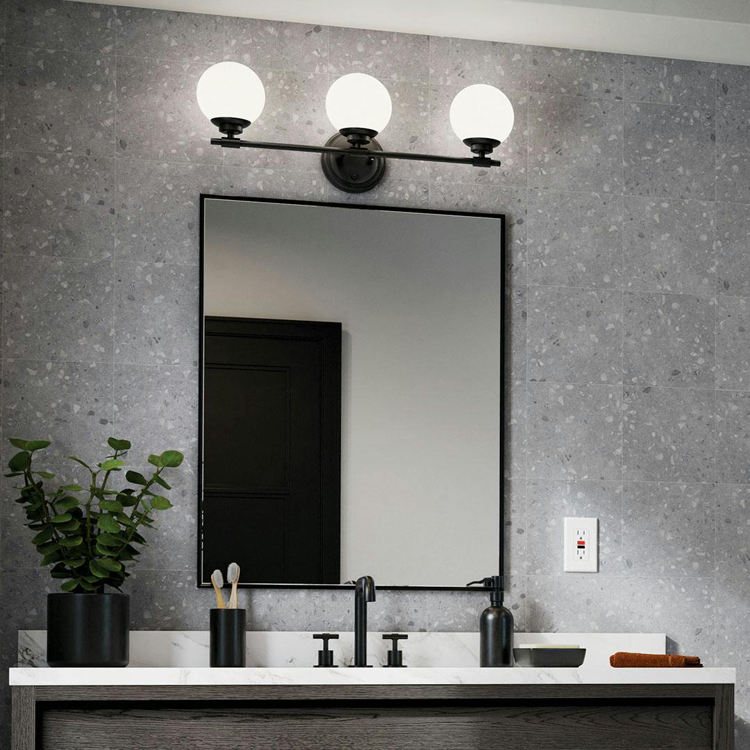 Day time bathroom with the Benno 24.5 Inch 3 Light Vanity Light with Opal Glass in Black