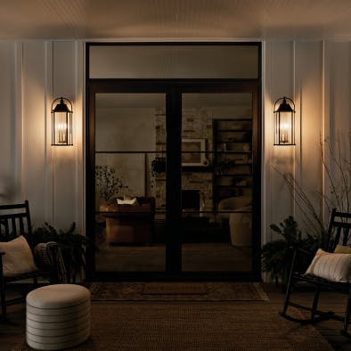 Front door entrance lit with Harbor Row outdoor wall sconces at night 