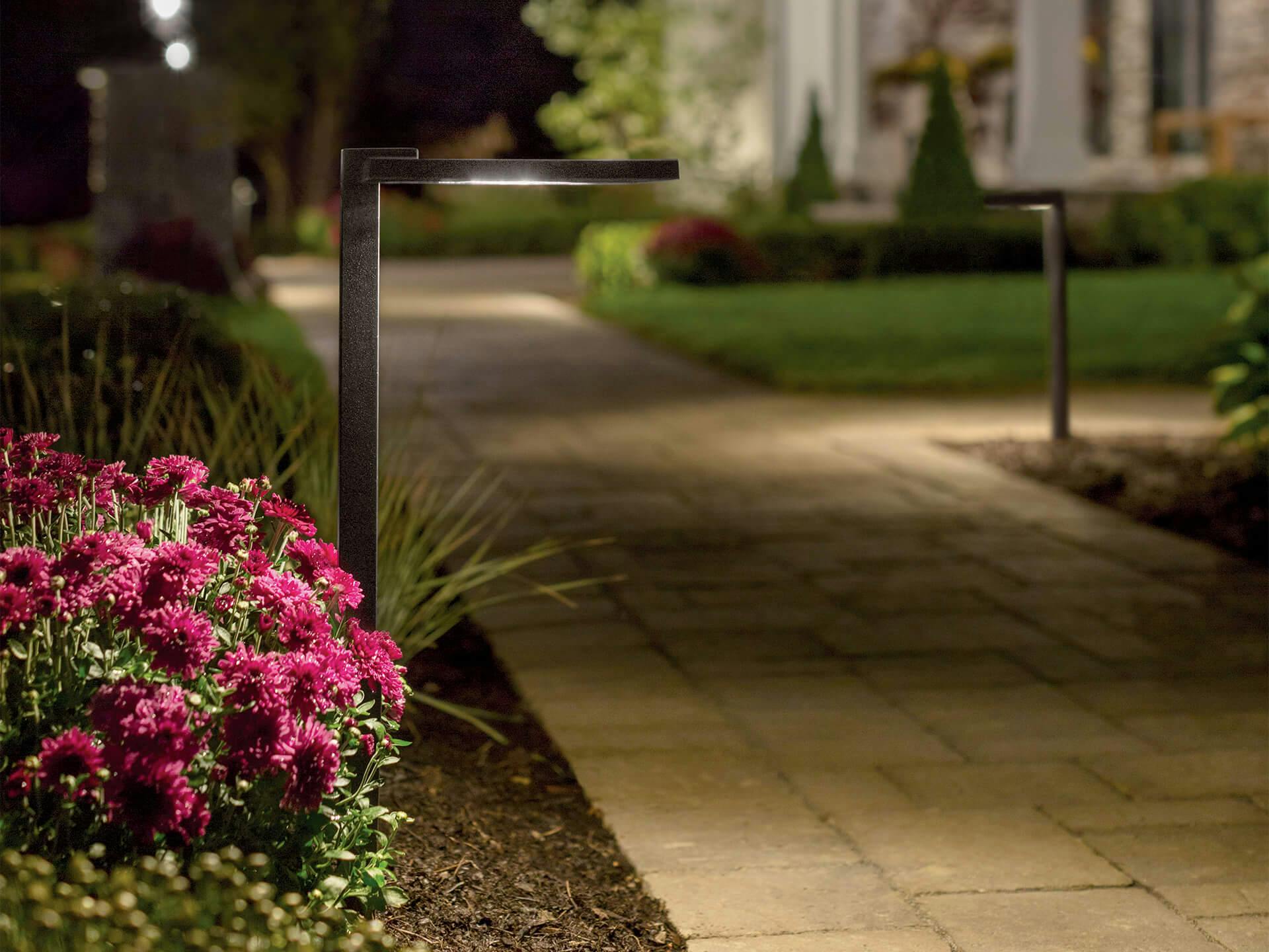 A landscape path lit up with Modern Farm house outdoor post lights