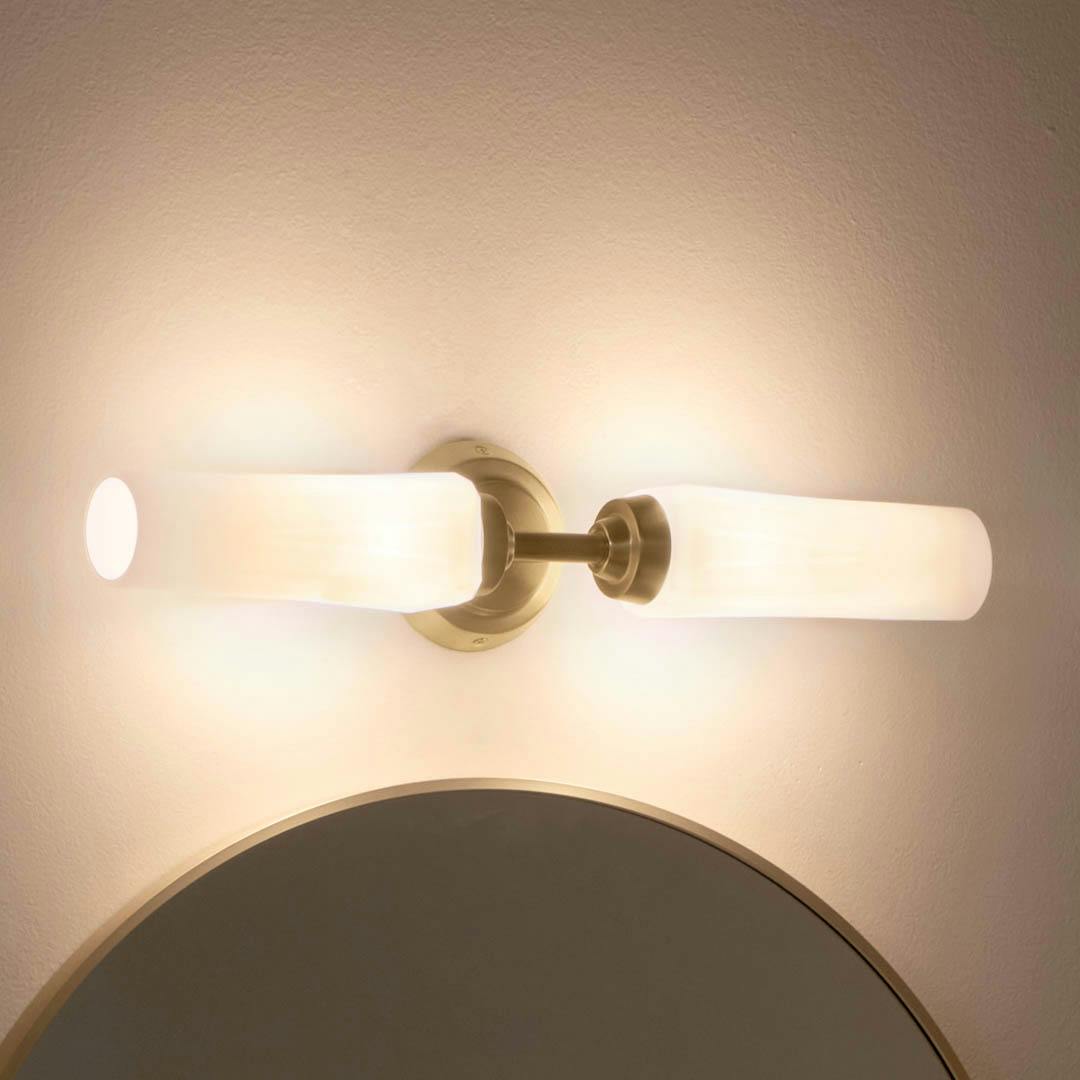 Night time bathroom with Truby 19.75 Inch 2 Light Vanity Light with Satin Etched Cased Opal Glass in Champagne Bronze