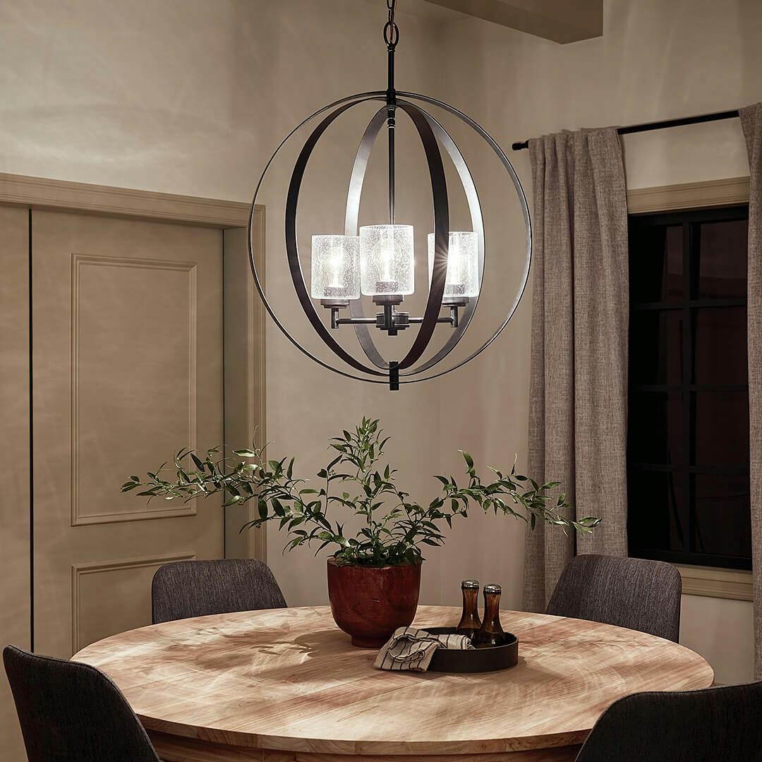Winslow™ 3 Light Chandelier Black in a dining room at night
