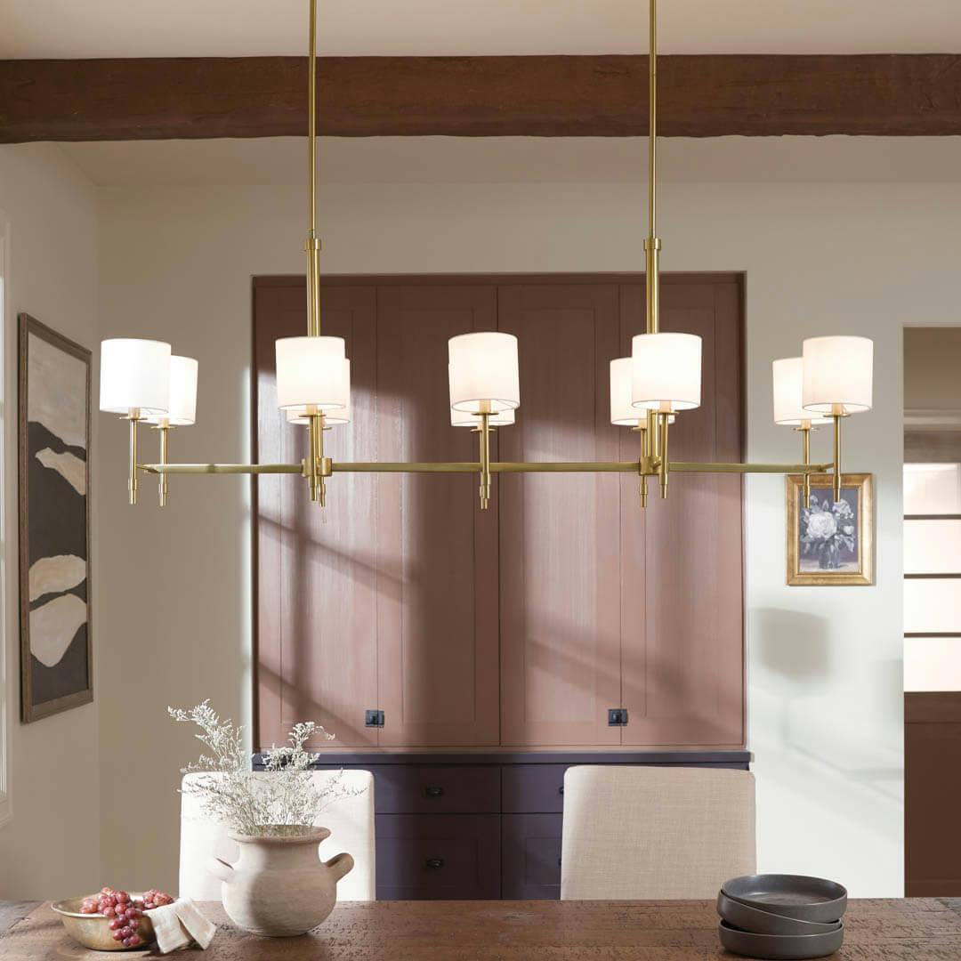 Day time dining room with Ali 56.5" 10 Light Linear Chandelier Brushed Natural Brass