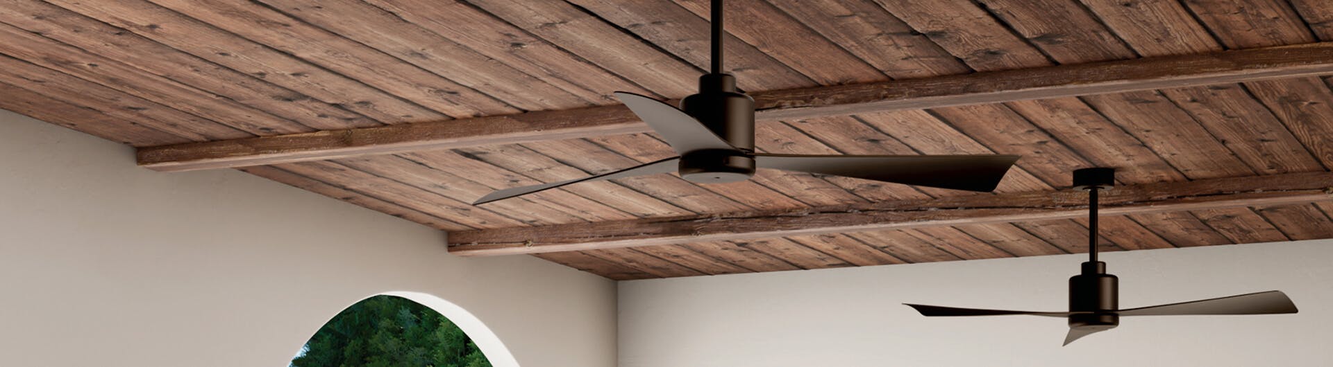 Two True ceiling fans in satin natural bronze mounted to a wooden ceiling