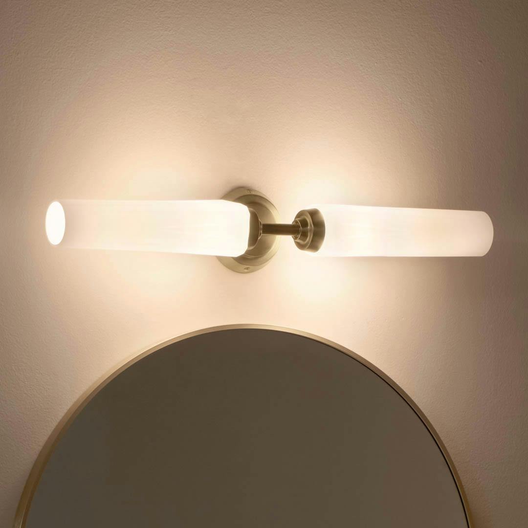 Night time bathroom with Truby 24.75 Inch 2 Light Vanity Light with Satin Etched Cased Opal Glass in Champagne Bronze