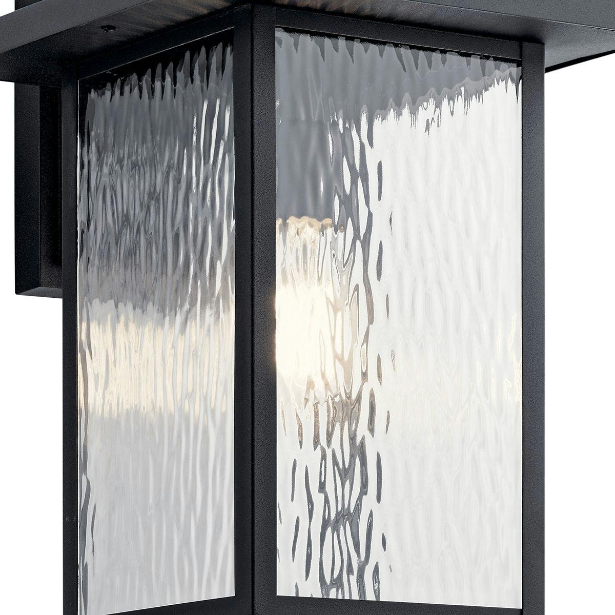 Close up view of the Capanna Wall Light - Water Glass Black on a white background