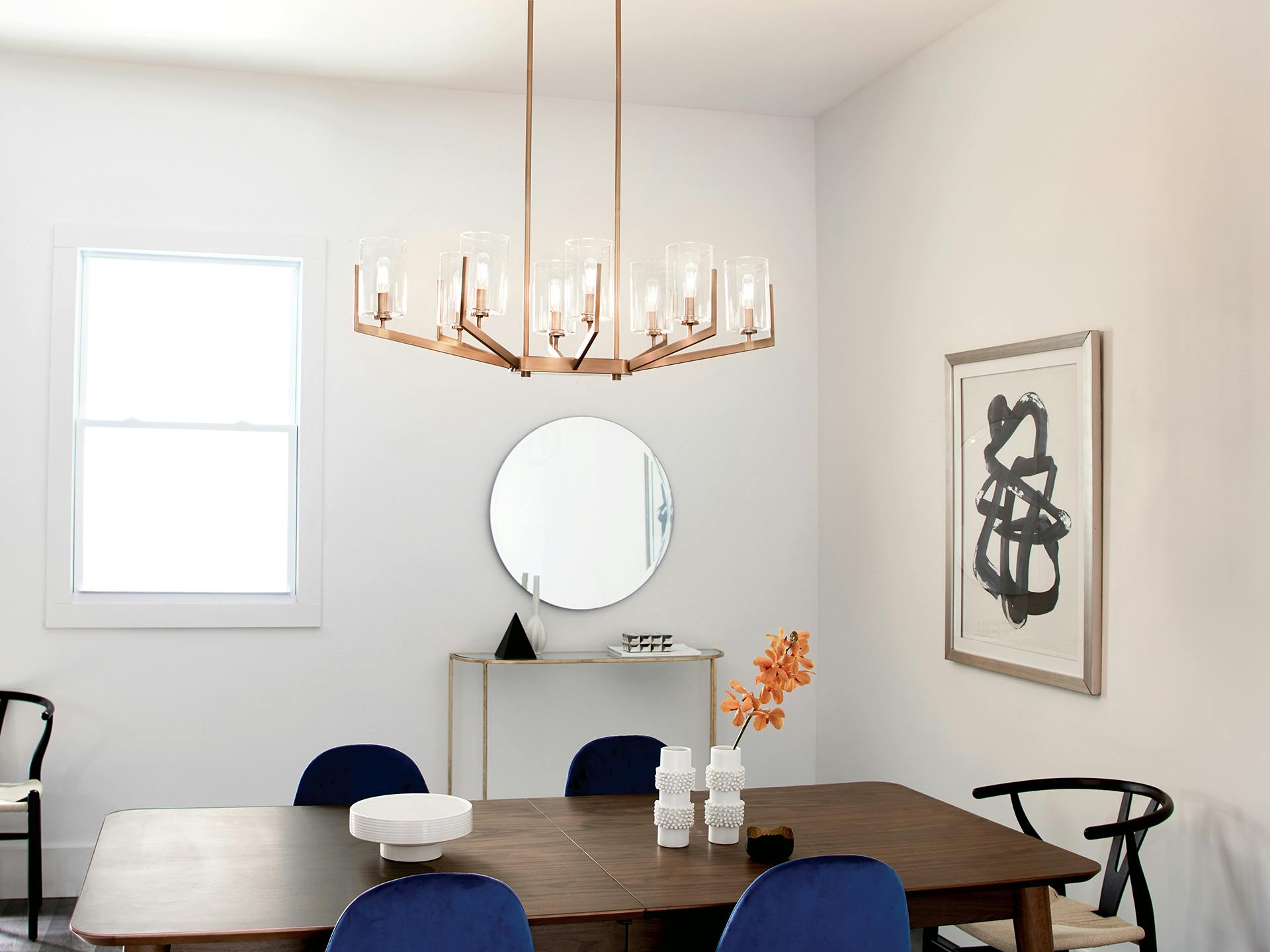 Brushed Natural Brass Nye Chandelier hanging over Mid-Century Modern dining room table