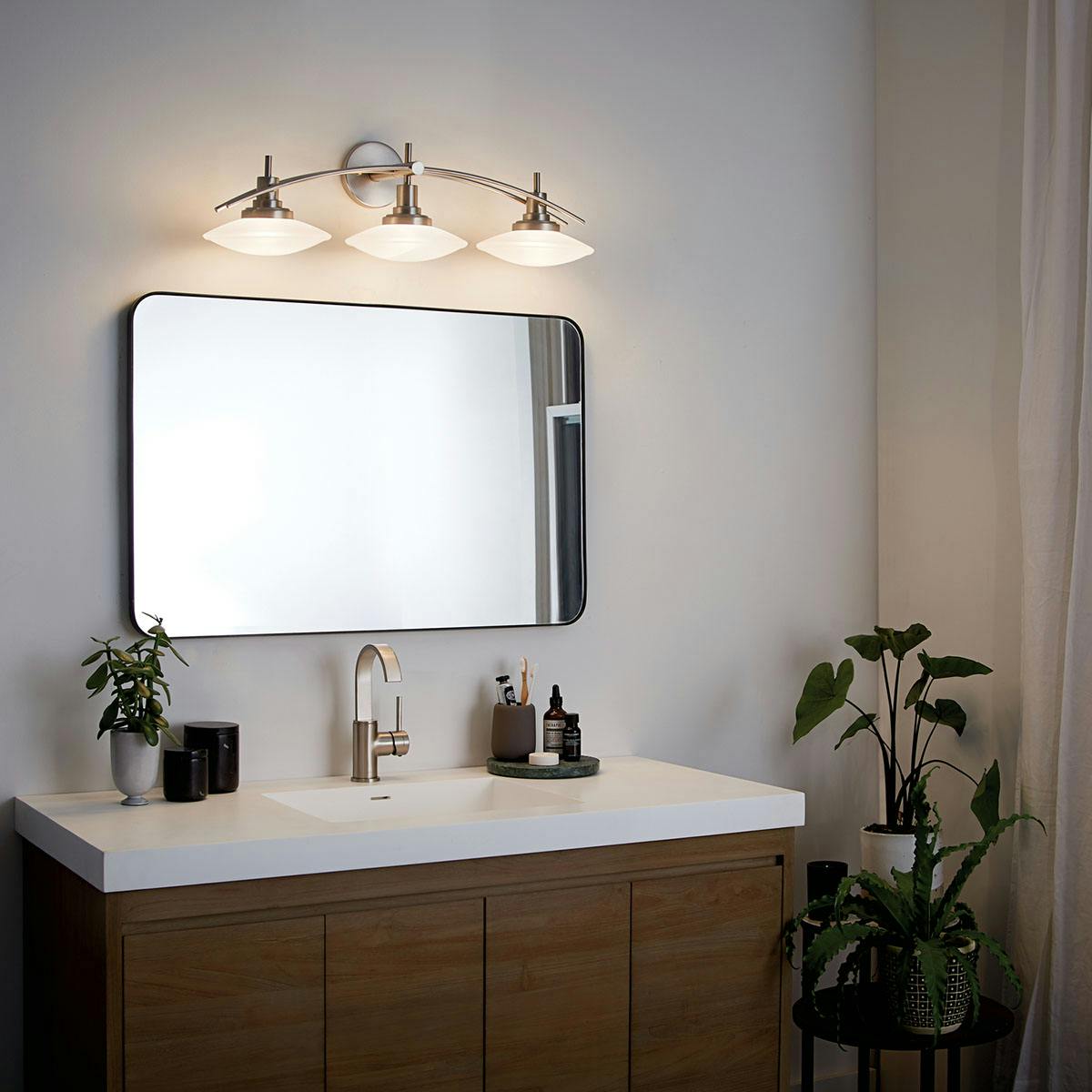 Night time bathroom image featuring Structures vanity light 6463NI