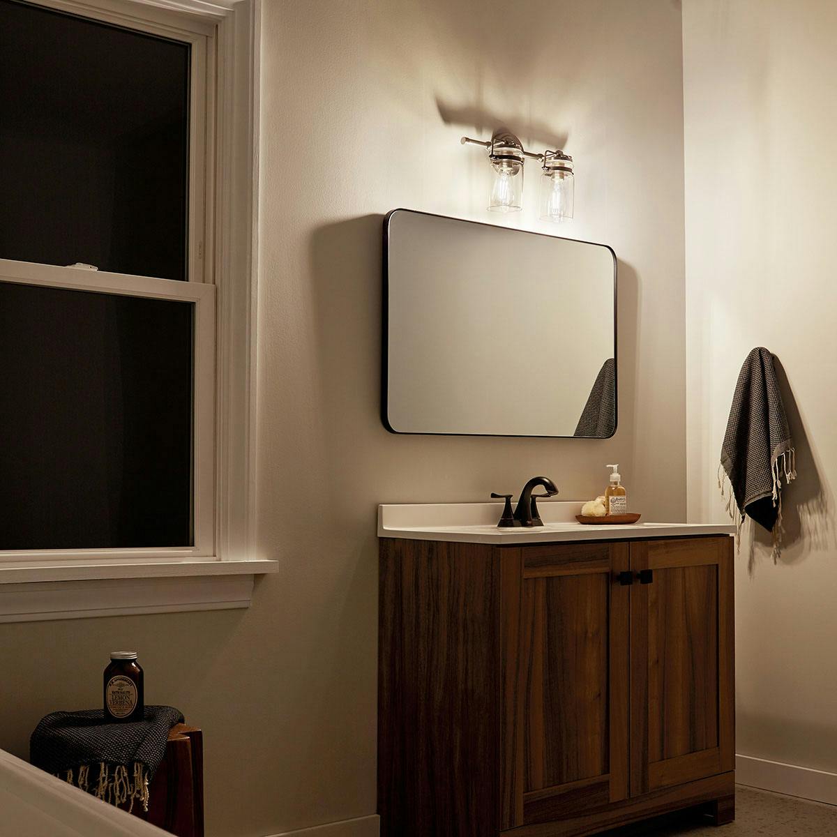 Night time Bathroom featuring Brinley vanity light 45688NI