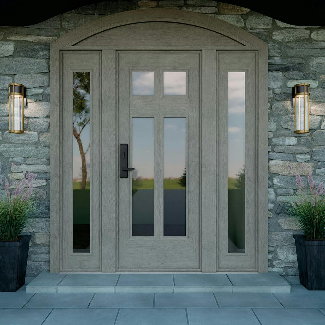 Stone exterior with the Camillo 20" LED Outdoor Wall Light with Clear Seeded Glass in Textured Black with Natural Brass