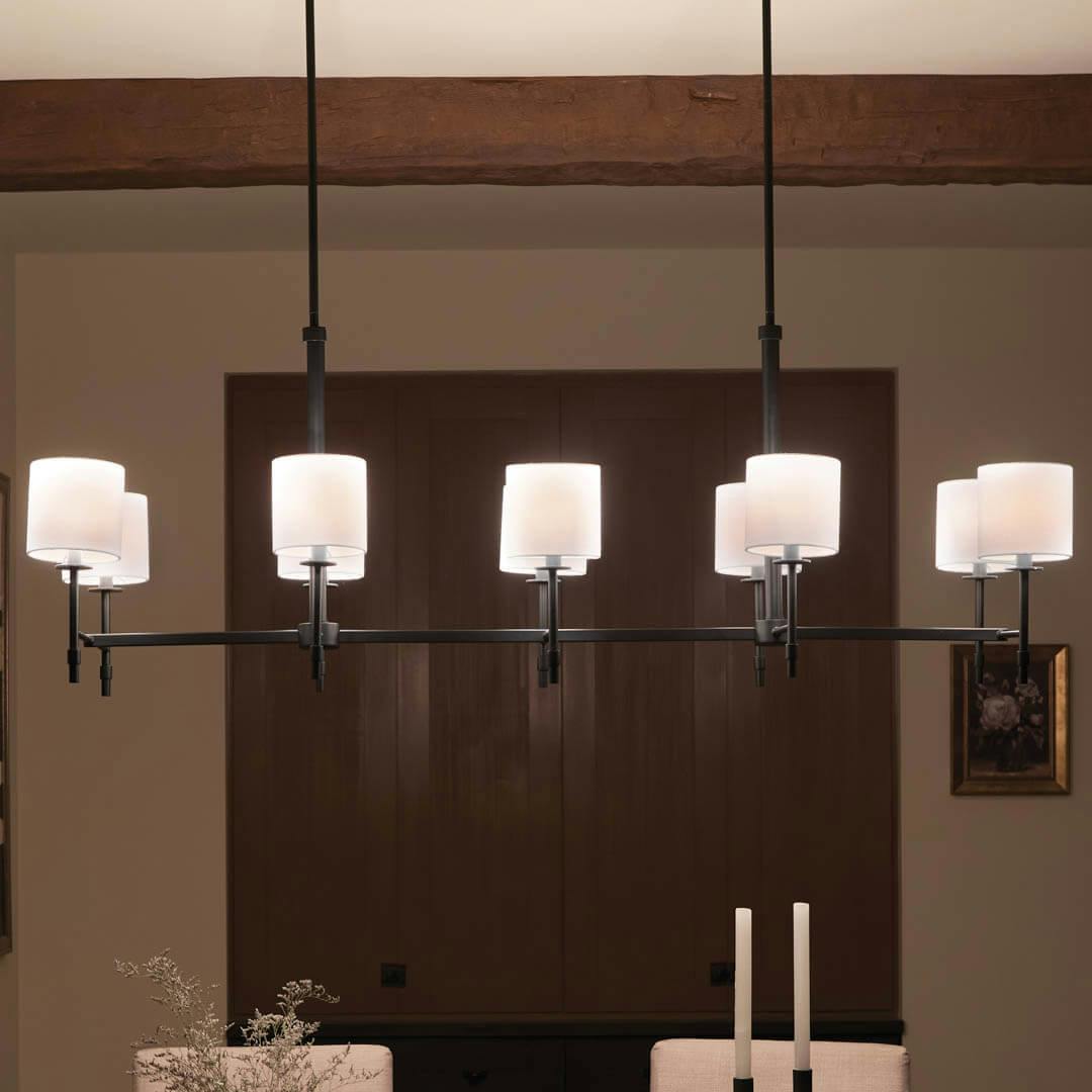 Night time dining room with Ali 56.5" 10 Light Linear Chandelier Black