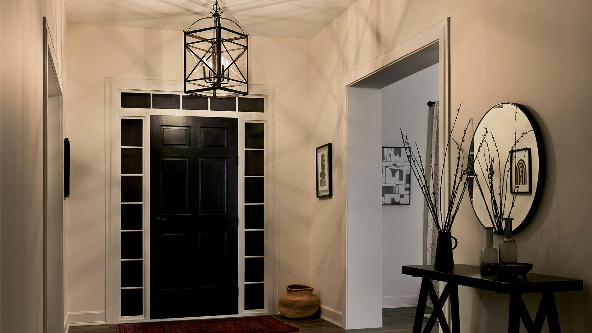 Soft lit entryway with an Arborwood pendant hanging above the front door casting angular shadows around the room