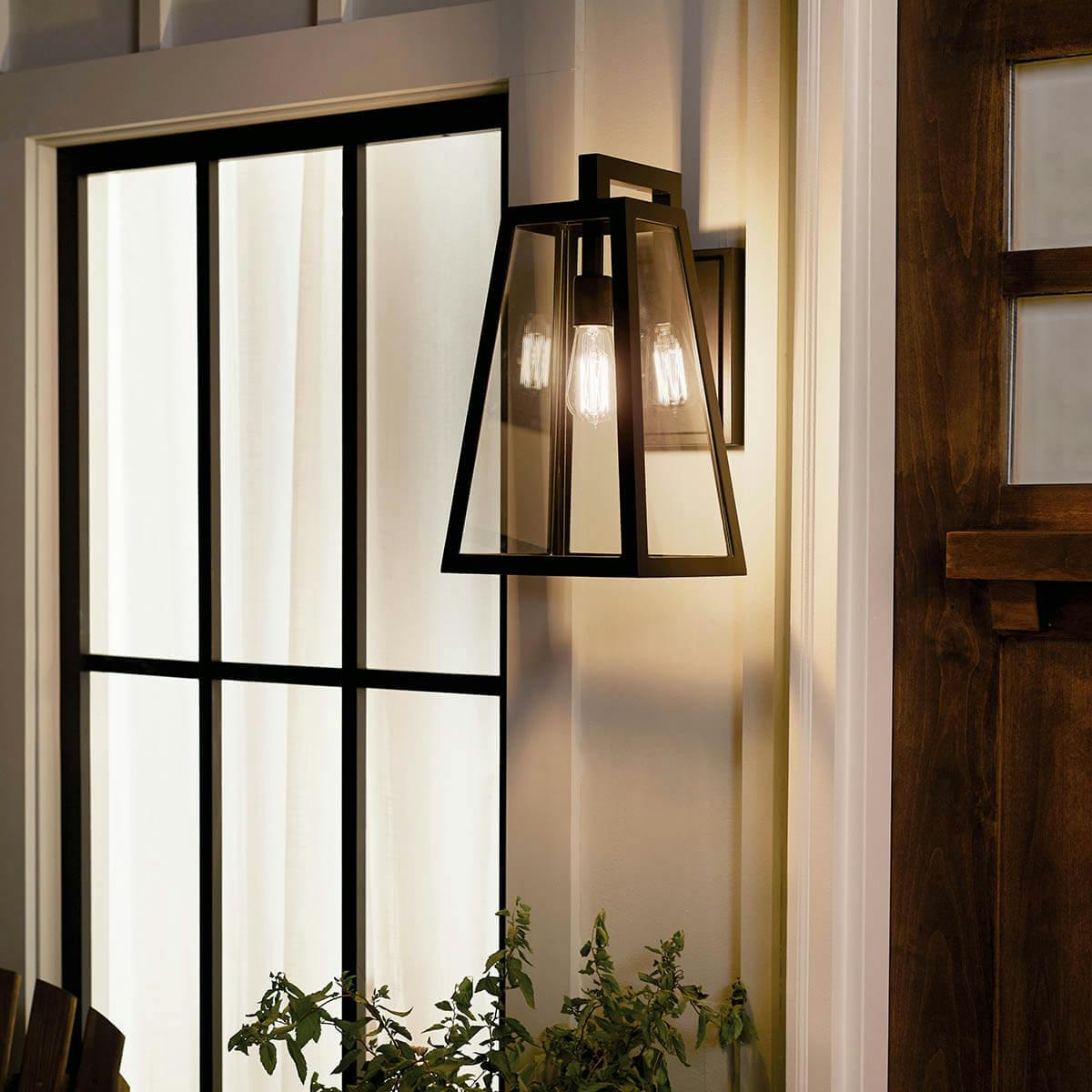 Night time porch with Delison 16.75 " 1 Light Wall Light Black
